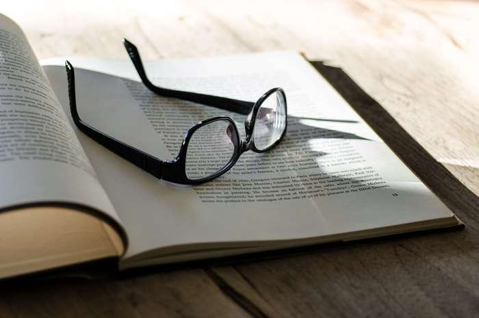 Glasses on an open book on a table