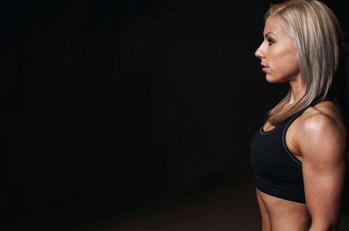Fit woman in sportswear in a gym 4K