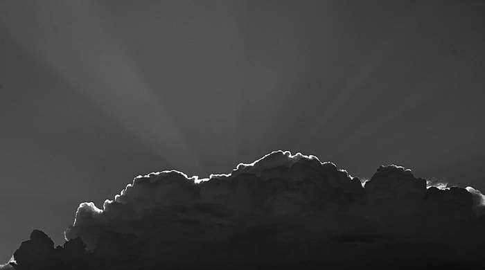 Sunlight shining through dark clouds