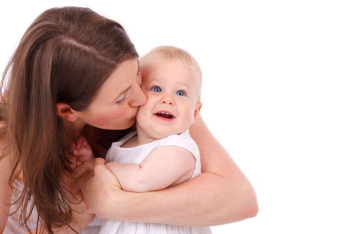 Mother kissing her baby girl