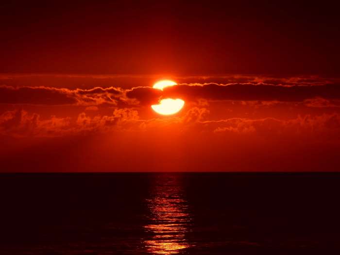 Sunset over the ocean with clouds