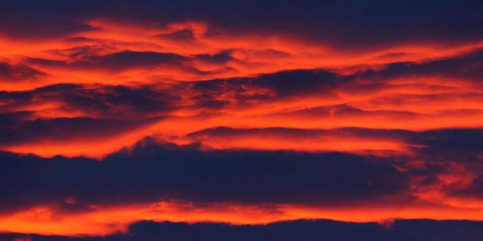Dramatic sunset clouds in orange and dark blue 4K