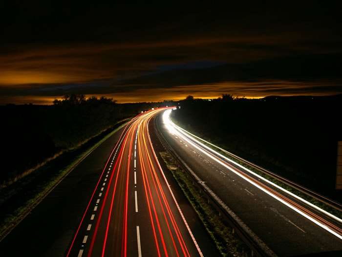 Long exposure of a highway at night with light trails