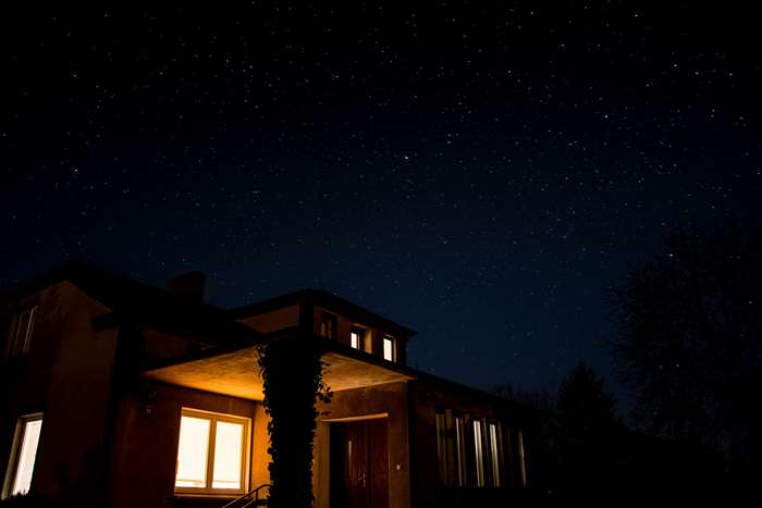 House at night with stars
