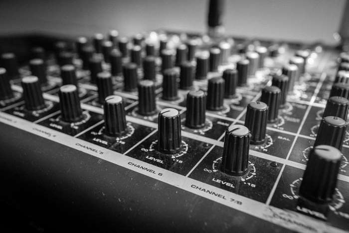 Close-up of a sound mixing console with multiple channels