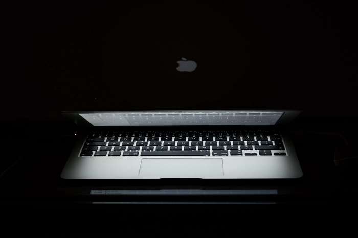 Apple MacBook laptop in dark 4K