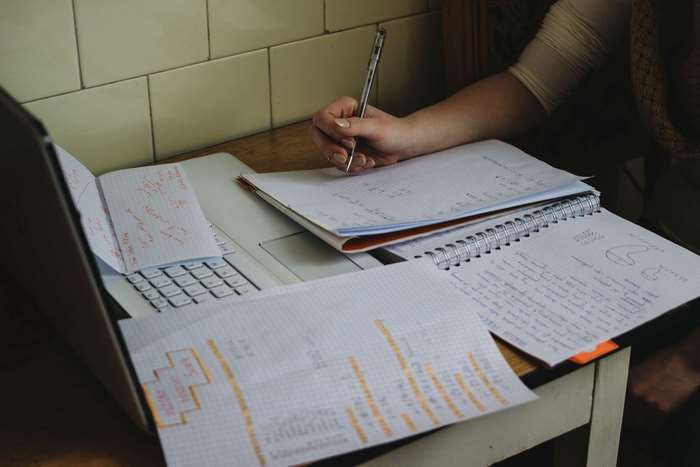 Katie studying with laptop and notebooks