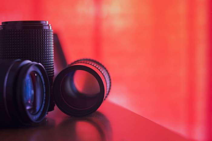 Camera lenses on a red background
