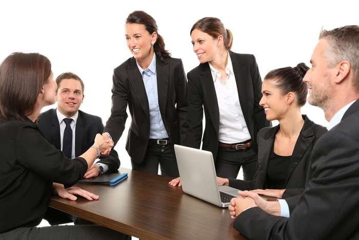 Business meeting with handshake and laptop