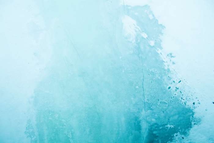 Blue ice with white patches and cracks