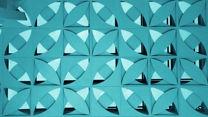 Geometric pattern with overlapping shapes in teal