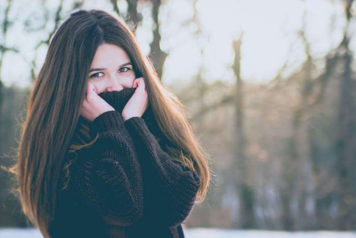 Young woman in a sweater in a forest