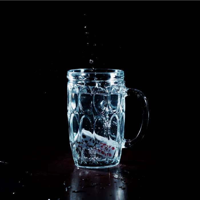 Dice falling into a glass of water