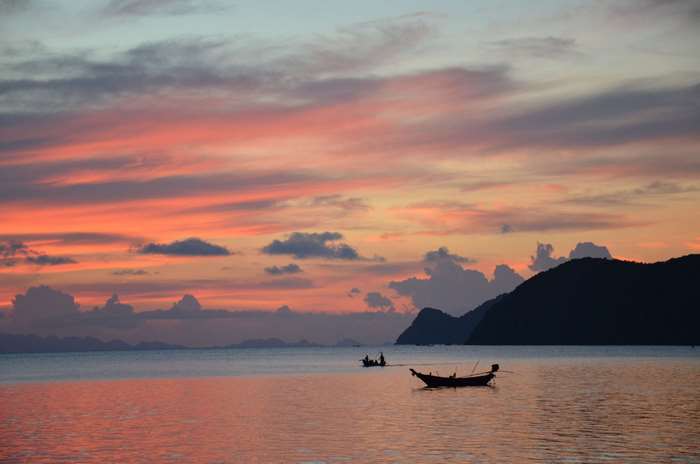 Sunset over the sea with islands and boats