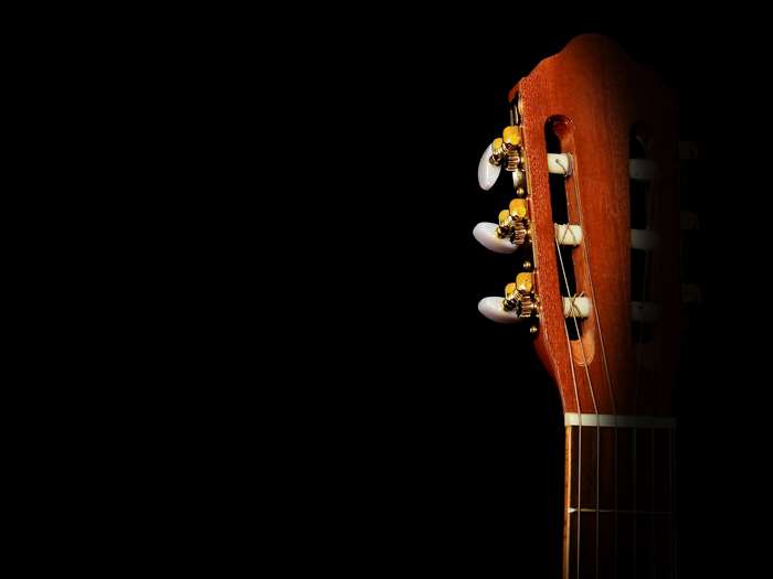 Close up of a wooden acoustic guitar headstock