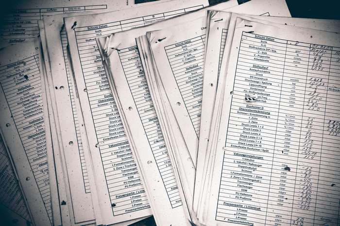 Stack of Old Documents with Handwritten Data