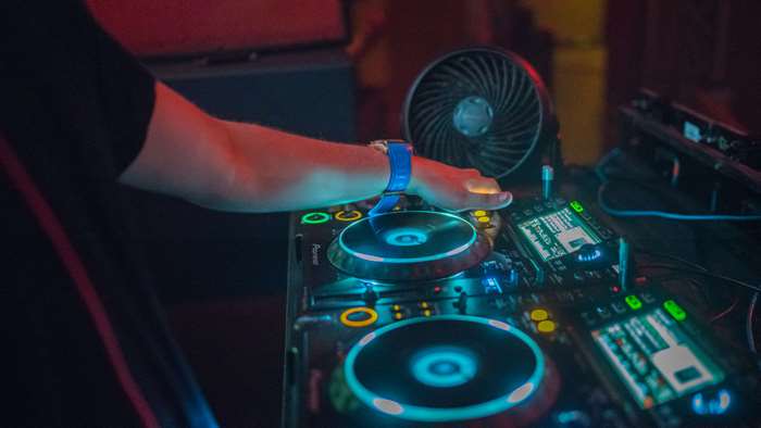 DJ playing music on equipment 4K