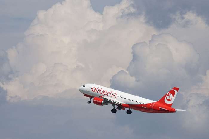 Air Berlin airplane taking off with clouds