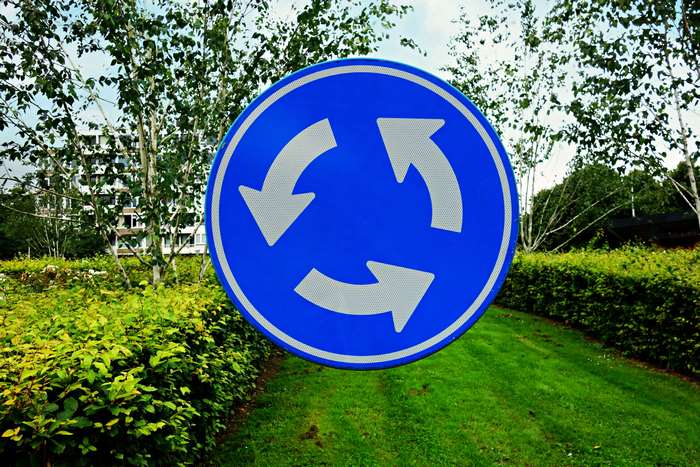 Roundabout traffic sign with arrows