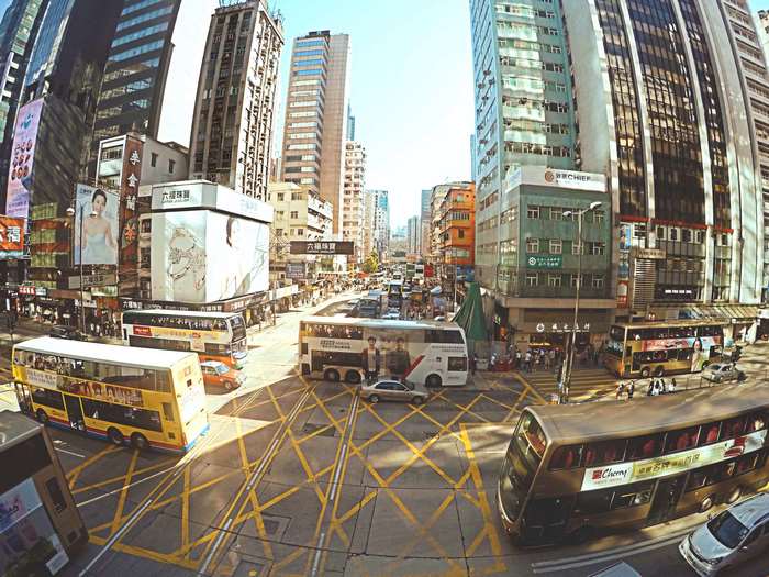 Hong Kong street with double-decker buses and tall buildings