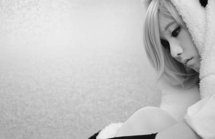 Girl in panda costume looking down