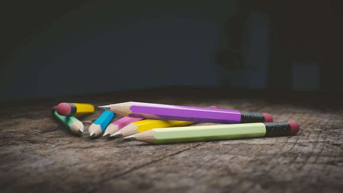 Pile of colorful pencils on a wooden surface