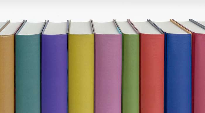 Row of colorful hardcover books on a white background