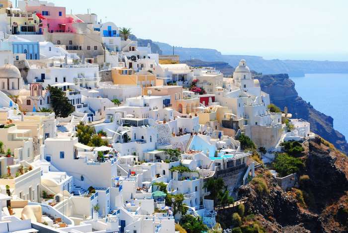 White buildings on a cliffside in Oia, Santorini, Greece overlooking the sea
