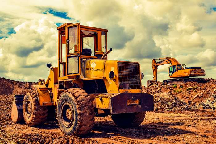 Yellow Allis-Chalmers bulldozer and excavator on a construction site 4K