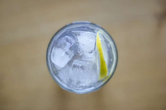 Glass of iced drink with lemon slice