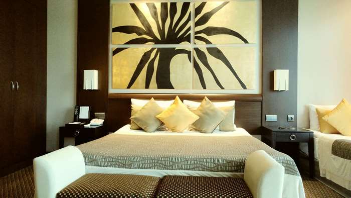 Hotel room with large artwork above bed