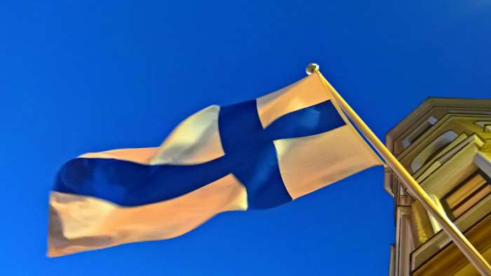 Finnish flag waving in front of a building