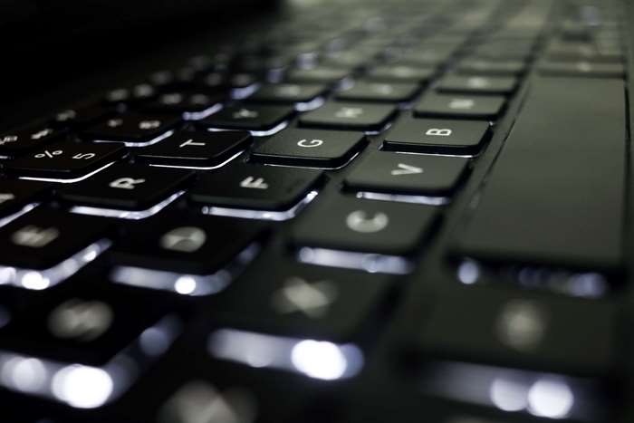 Close-up of a black backlit laptop keyboard 4K