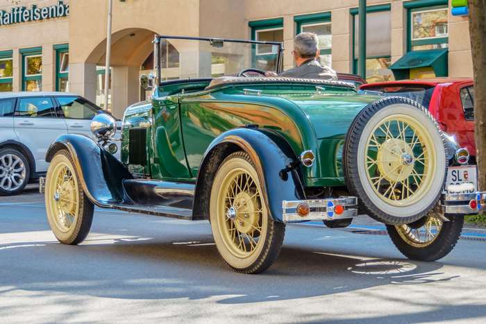 Green classic convertible car with spare tire