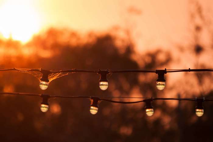 String of lights against sunset sky