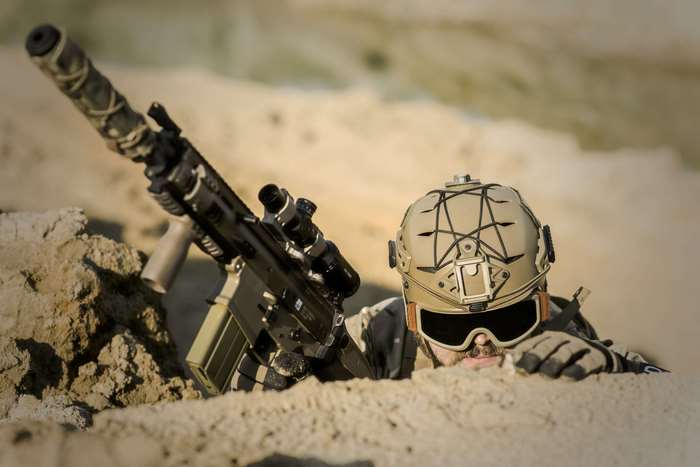 Soldier in desert with rifle