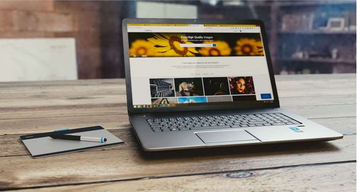 Laptop and graphics tablet on a wooden table