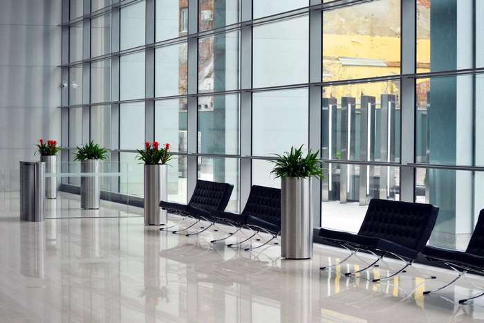 Modern office lobby with black chairs and plants