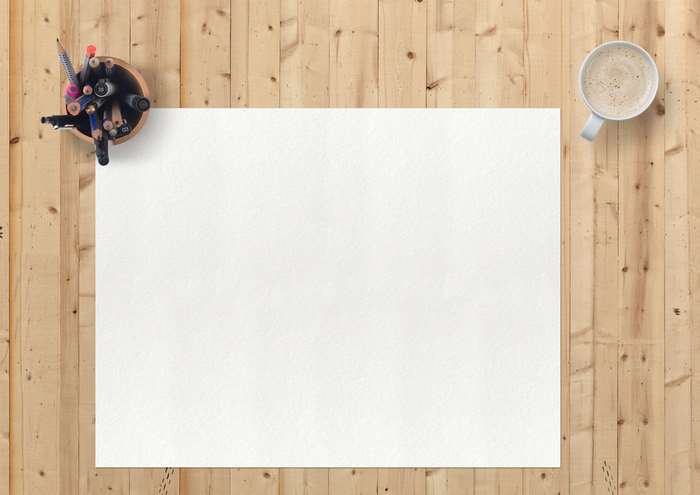 Blank paper, coffee cup, and pens on a wooden table 4K