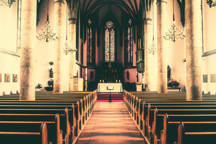 Church interior with pews and stained glass windows