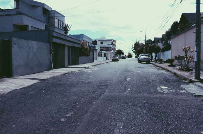 Street view in Ecuador with cars and houses
