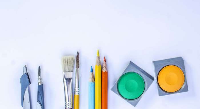 Art supplies including brushes, pencils, and watercolors