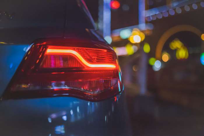 Close up of a car's red tail light at night