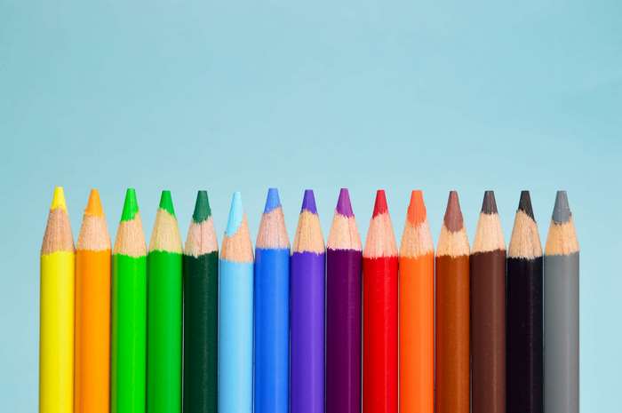 Colorful colored pencils on a blue background