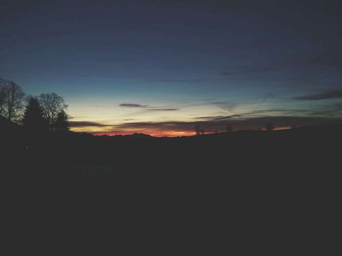 Minimalist sunset over hills and trees
