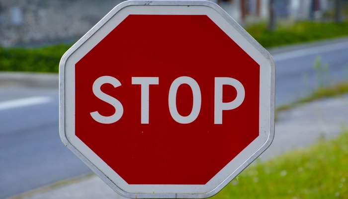 Red octagonal stop sign on a road