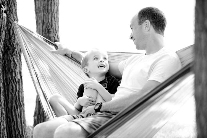 Father and son relaxing in a hammock