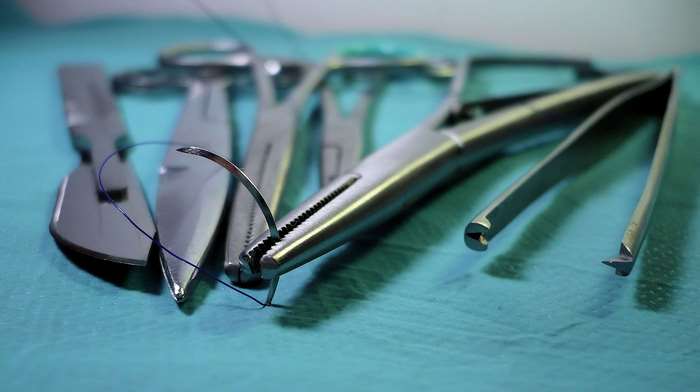 Surgical instruments with needle and thread