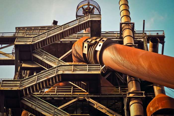 Industrial steel factory with large pipes and stairs