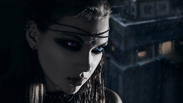 Gothic woman with blue eyes in the rain